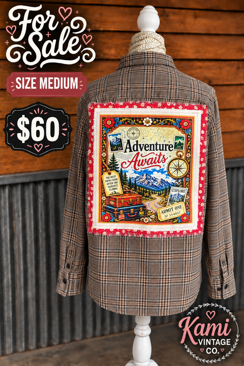 Size Medium plaid vintage flannel with an Adventure Awaits mountain, road trip, luggage, and compass back design